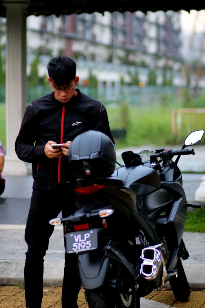Bryan with his motorcycle outdoors